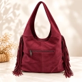 Bolso de hombro efecto ante con flecos en color camel y burdeos